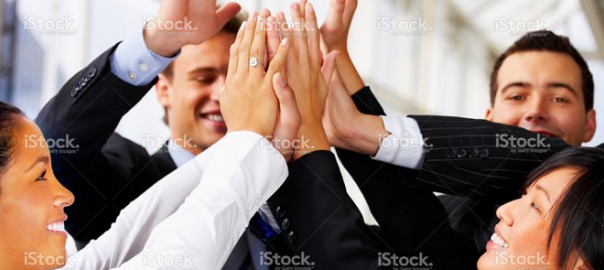 Diverse business team high-fiving in office