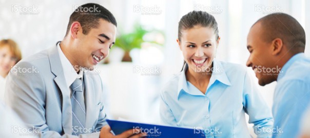 Three professionals reviewing document in office