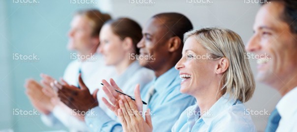 Diverse business team applauding at conference