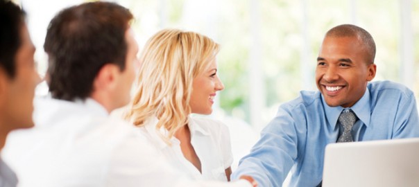 Smiling business professionals shaking hands in meeting