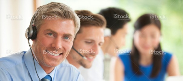 Smiling customer service agents wearing headsets