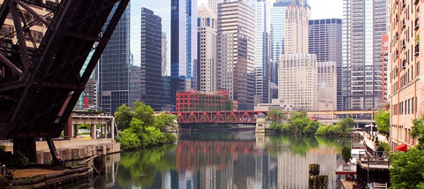 Chicago skyline over river with red bridge