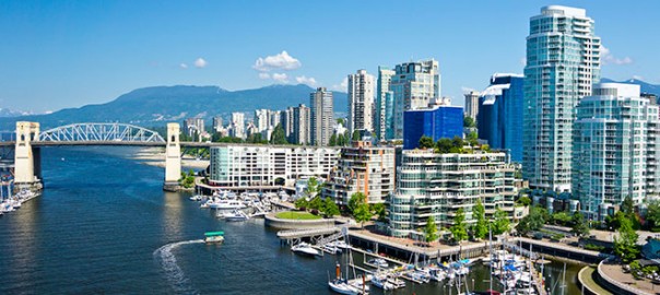 Waterfront city skyline with marina and mountains