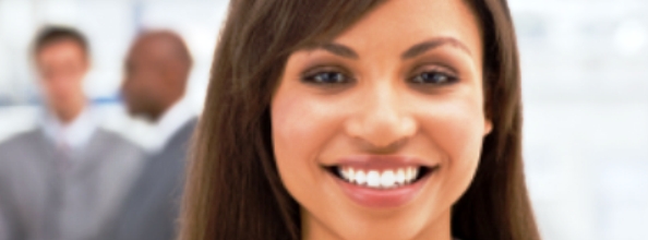 Close-up smiling businesswoman with blurred colleagues