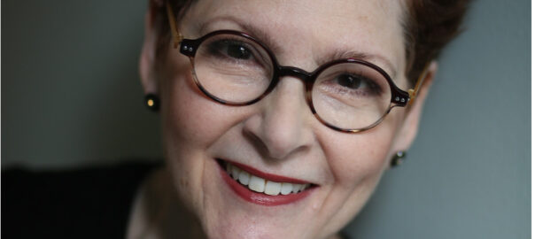 Portrait of smiling woman with round glasses