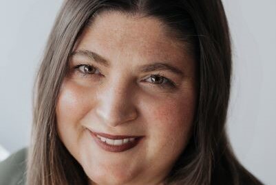 Friendly headshot of smiling woman with brown hair