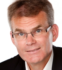 Man wearing glasses smiling corporate headshot
